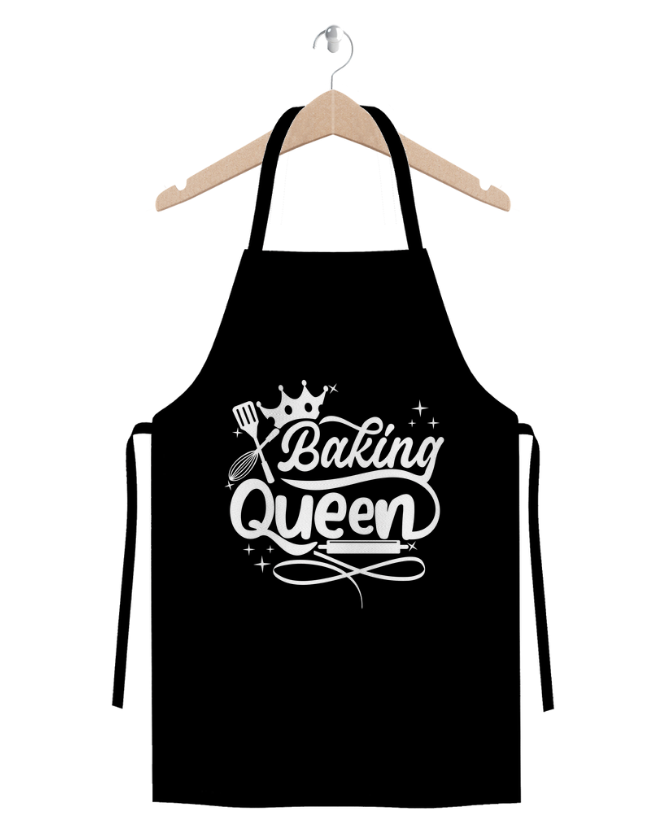 Baking Queen black cotton twill apron with crown and baking utensils graphic hanging on wooden hanger