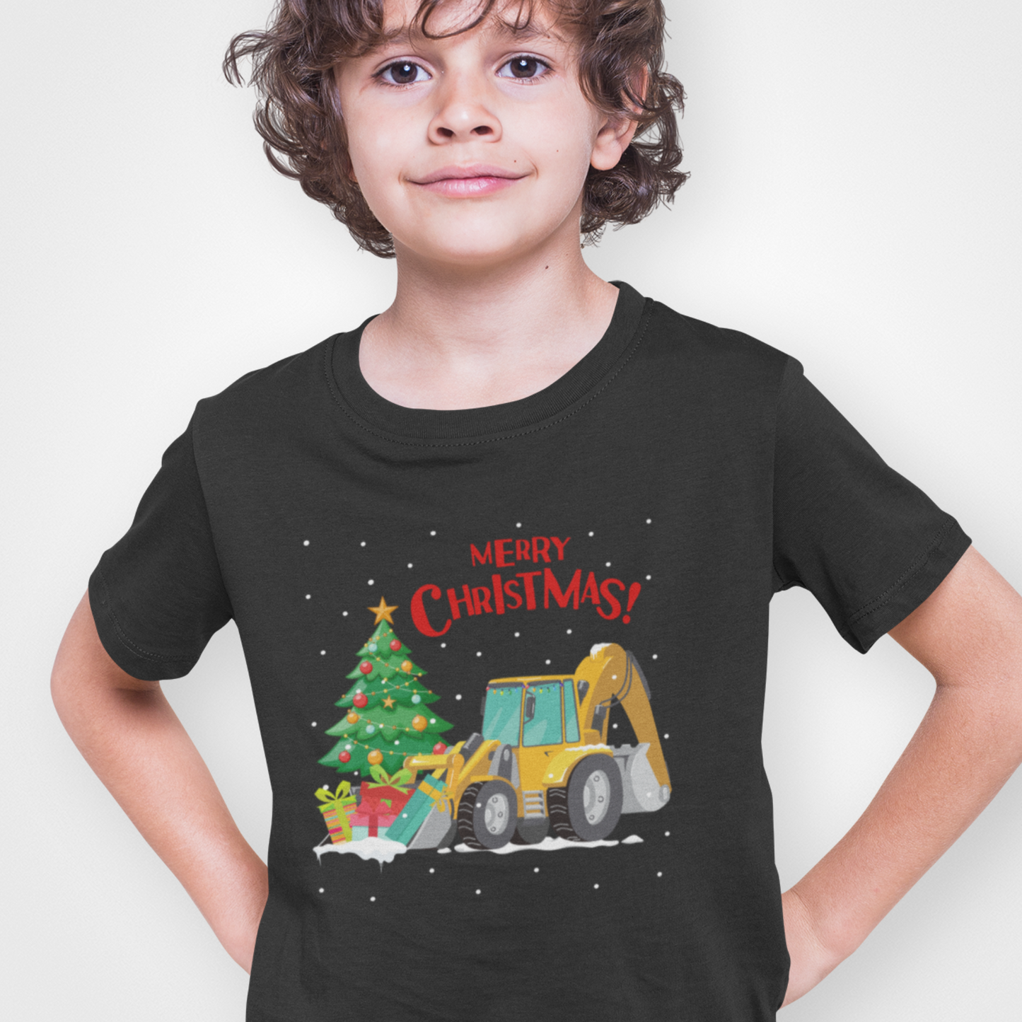 Child wearing a black t-shirt with a Christmas-themed design featuring a bulldozer and tree.