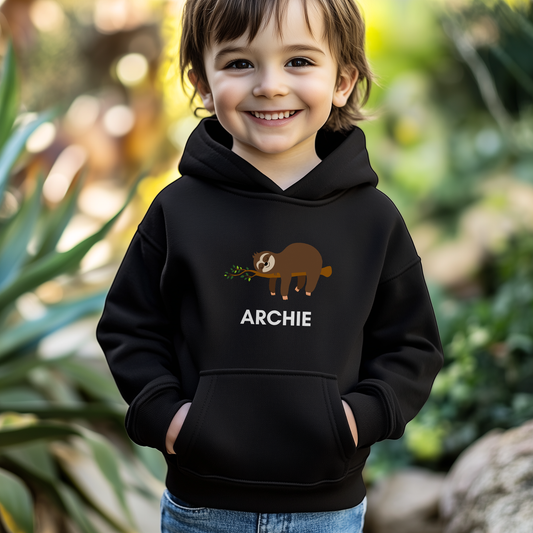 little boy pose in a wildlife zoo wearing a sleeping sloth on a branch graphic with custom name underneath