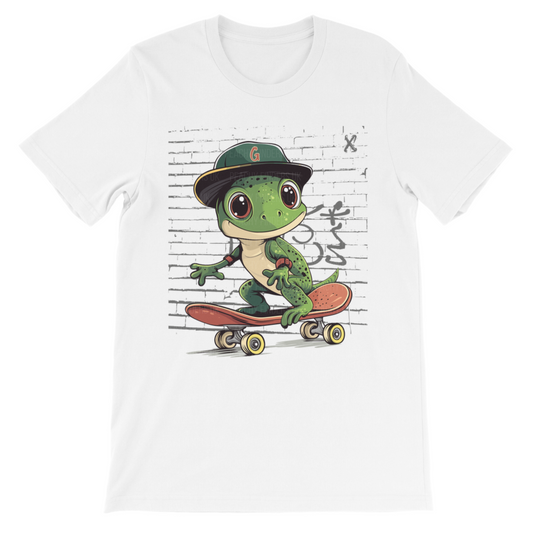 Boys white t-shirt featuring a cool cartoon gecko skateboarding in front of a graffiti wall, wearing a cap and elbow pads.