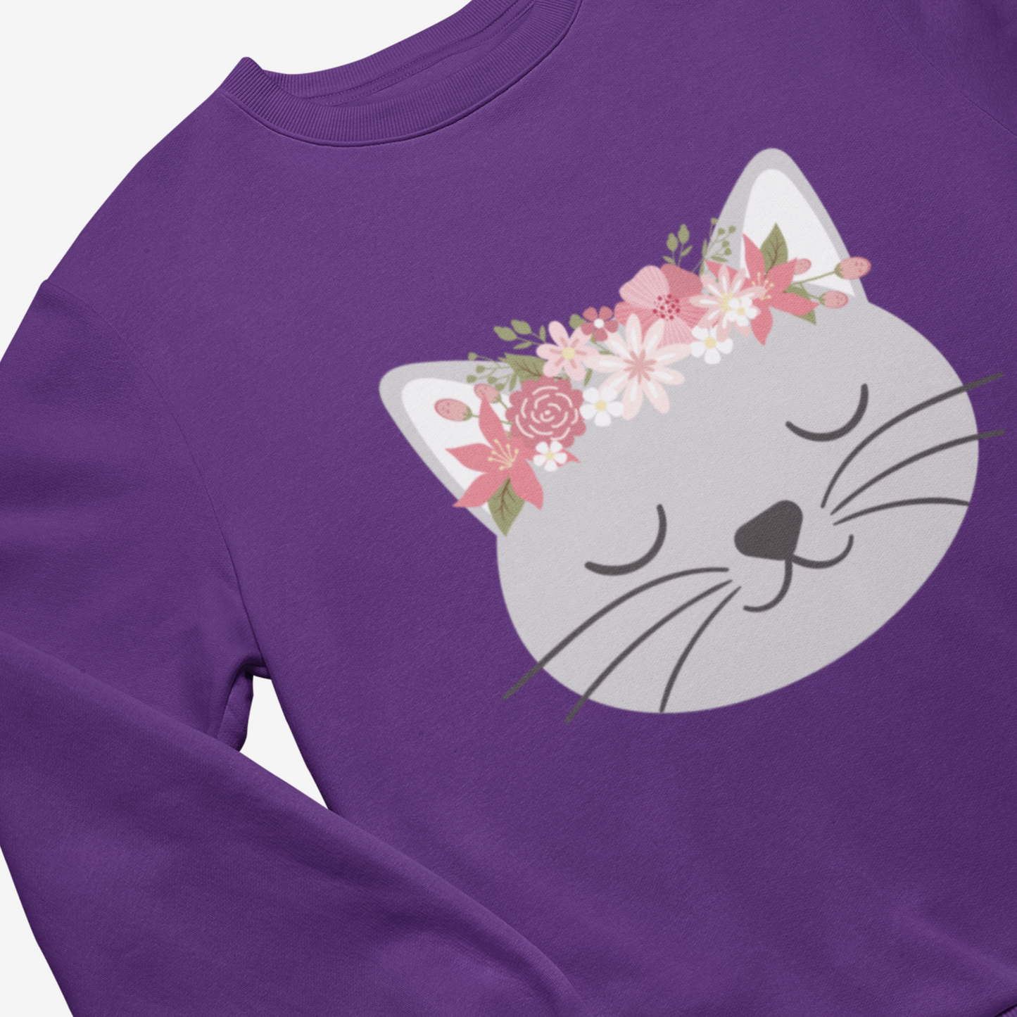 Girls Purple Cat Jumper featuring a cute grey cat face with closed eyes and a pink floral crown above its ears.