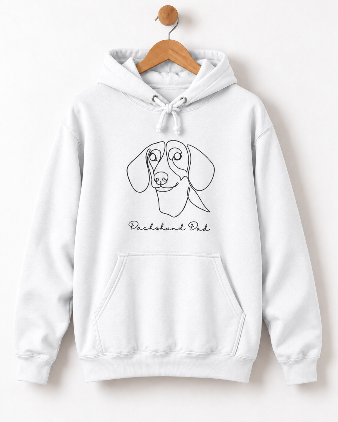 White adult hoodie on a wooden hanger featuring a minimalist dachshund line drawing and “Dachshund Dad” wording.