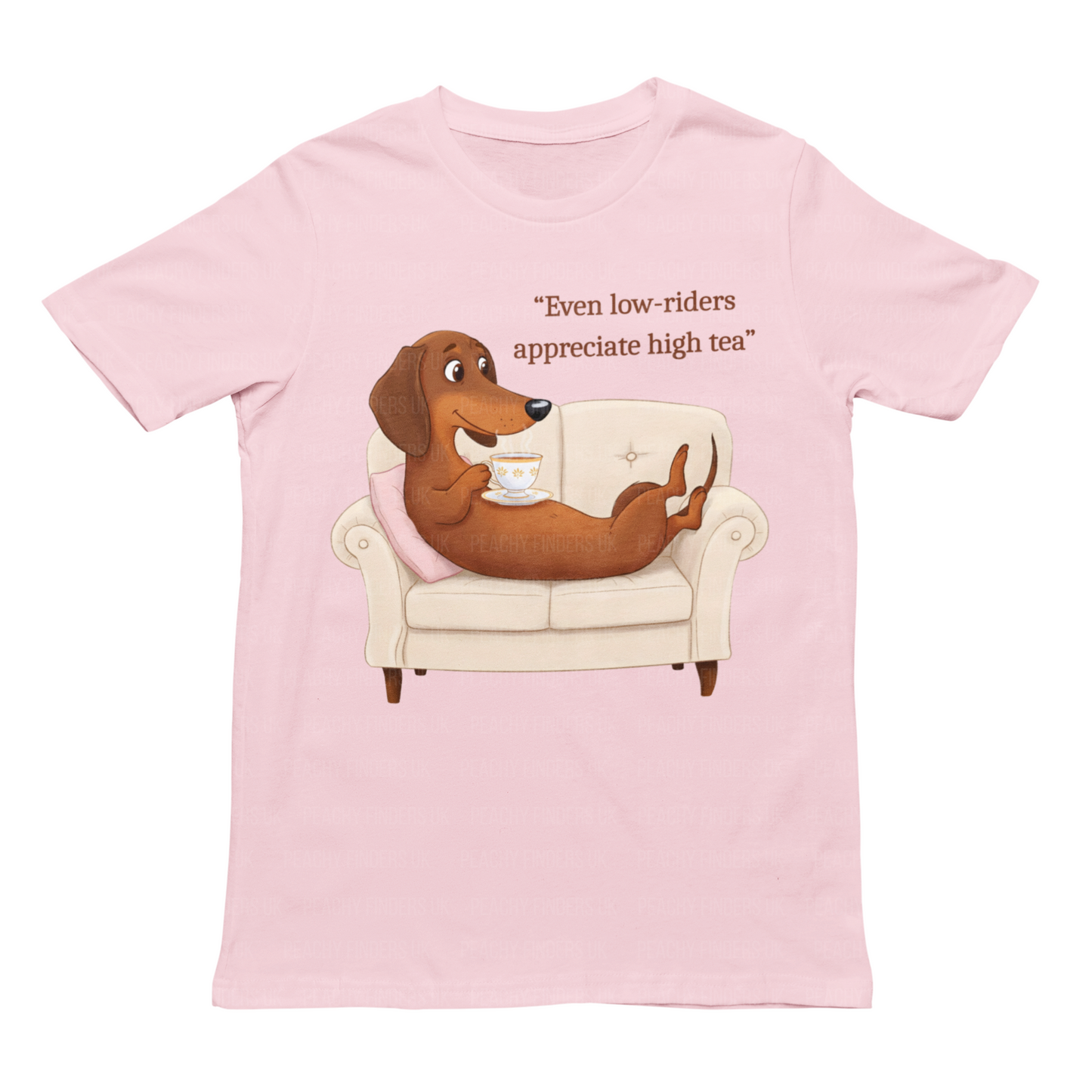 Women's soft pink t-shirt featuring an Illustrated dachshund reclining on a sofa, sipping tea, with the caption "Even low-riders appreciate high tea."