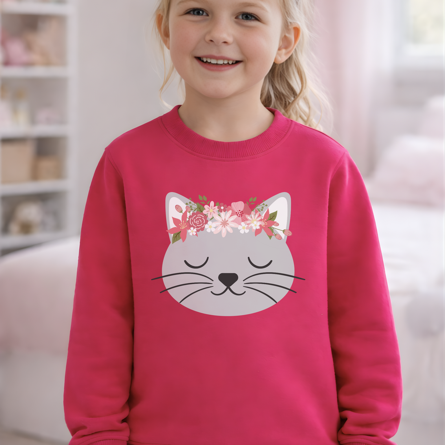 Young girl wearing a hot pink sweatshirt with a cat face design and floral headband.
