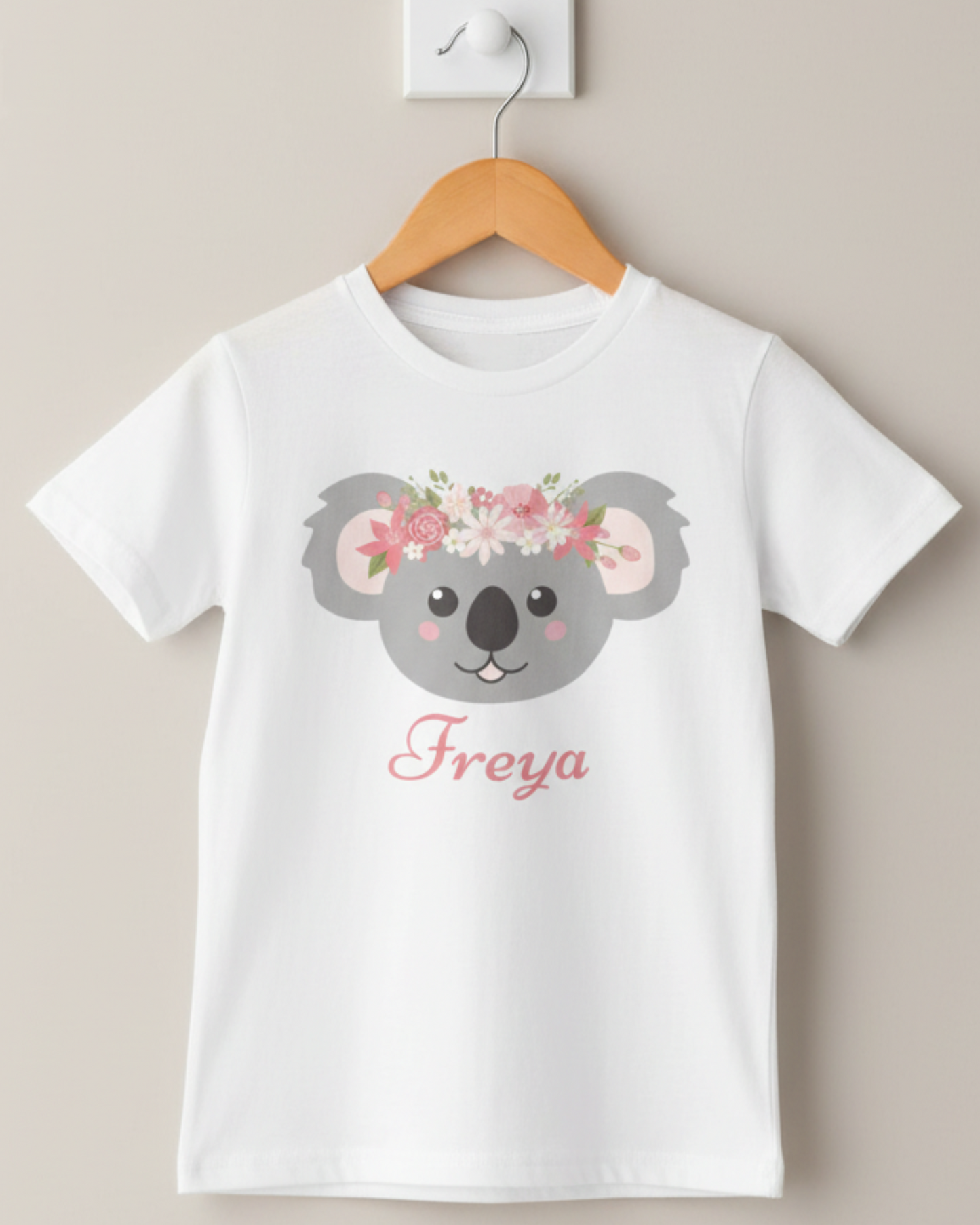 Personalised girls koala t-shirt with floral headband design and custom name Freya displayed on wooden hanger