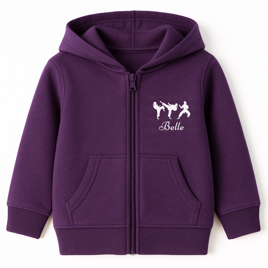 Purple girls full-zip hoodie featuring three white martial arts silhouettes in action poses printed on the left chest, personalised with the name “Belle”.