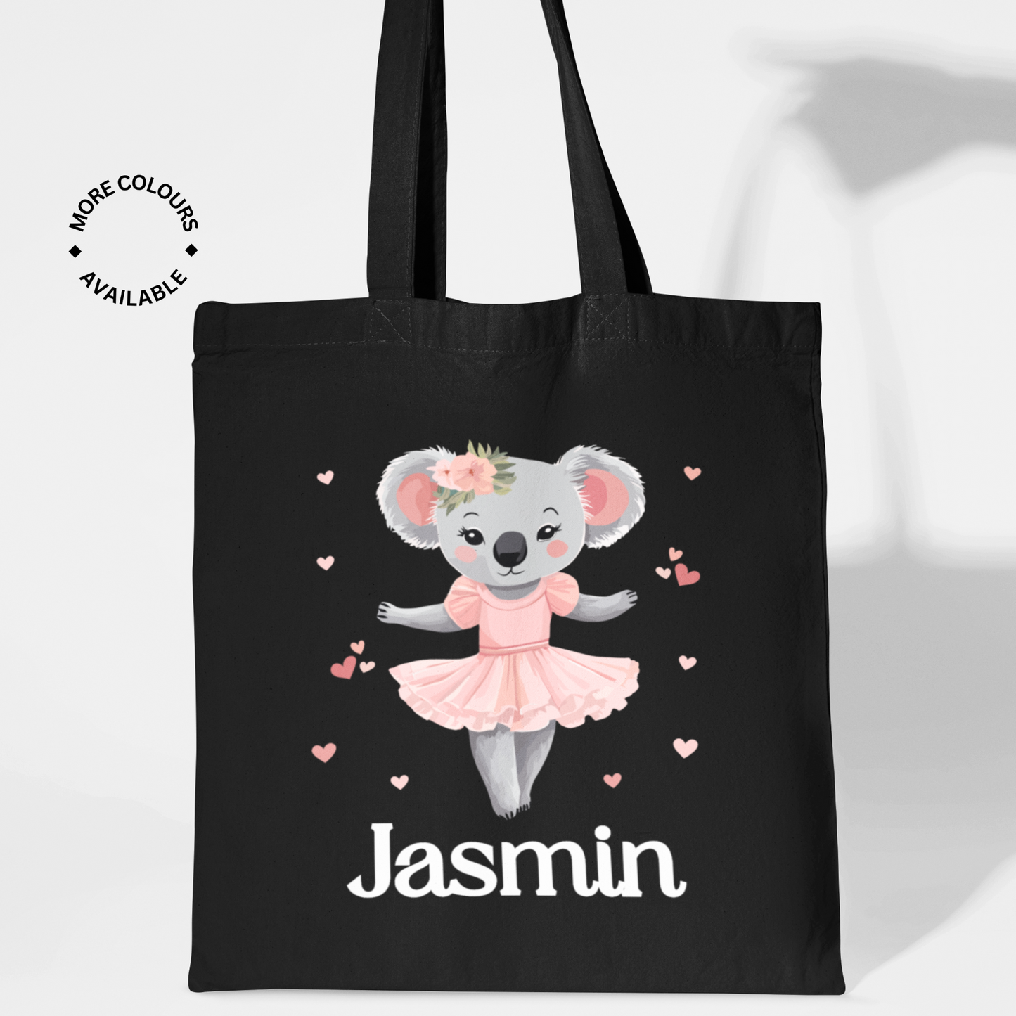 For girls, a black cotton tote bag featuring a cute ballerina koala in a pink tutu surrounded by hearts, with the name “Lauren” printed below in white text.