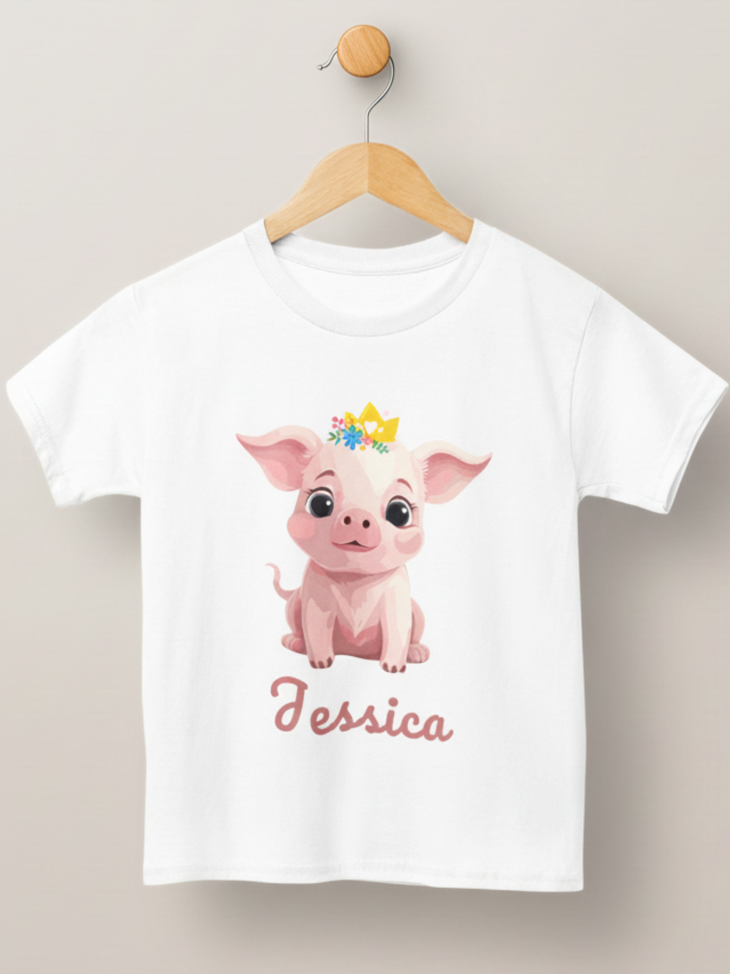 Girls white personalised princess pig t-shirt on hanger featuring a cute pig with crown and custom name Jessica.”