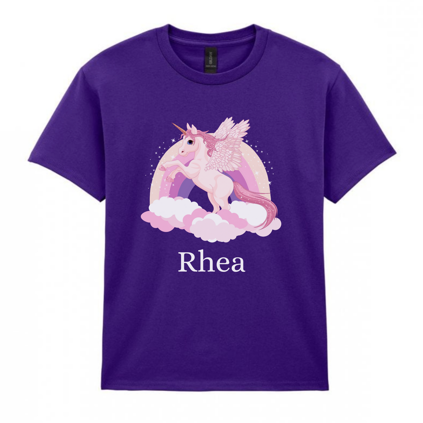 A kids purple short-sleeved t-shirt featuring a graphic of a pink unicorn with wings, a sparkly mane, tail, and hooves, standing on pink clouds. Behind the unicorn is a pastel rainbow. The name 'Rhea' is printed in white text below the unicorn graphic.