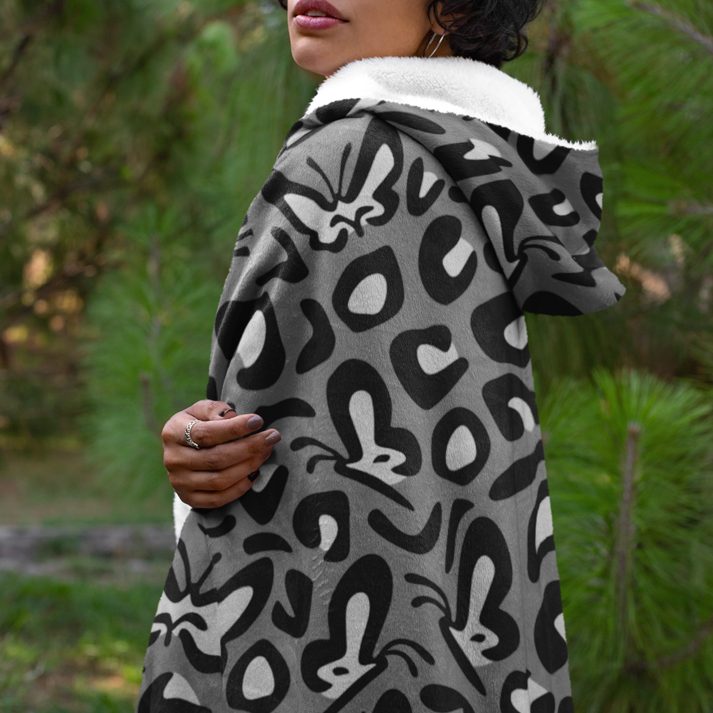 A black and white leopard print patterned hooded blanket