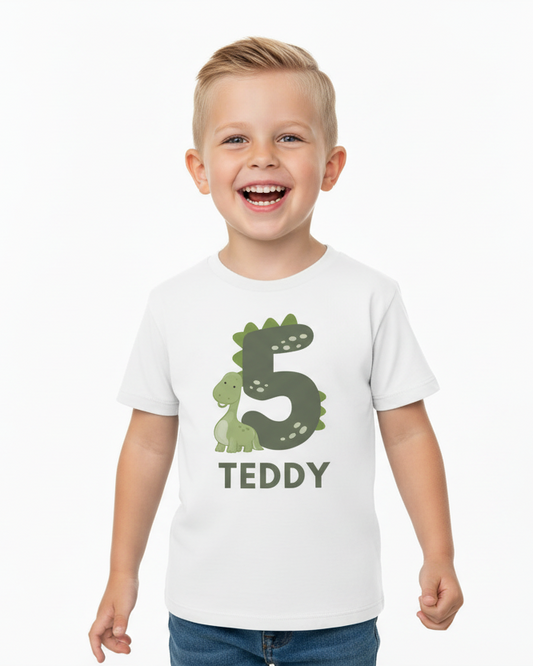 Happy boy wearing personalised 5th birthday dinosaur t-shirt with name Teddy, modern minimal birthday outfit for boys