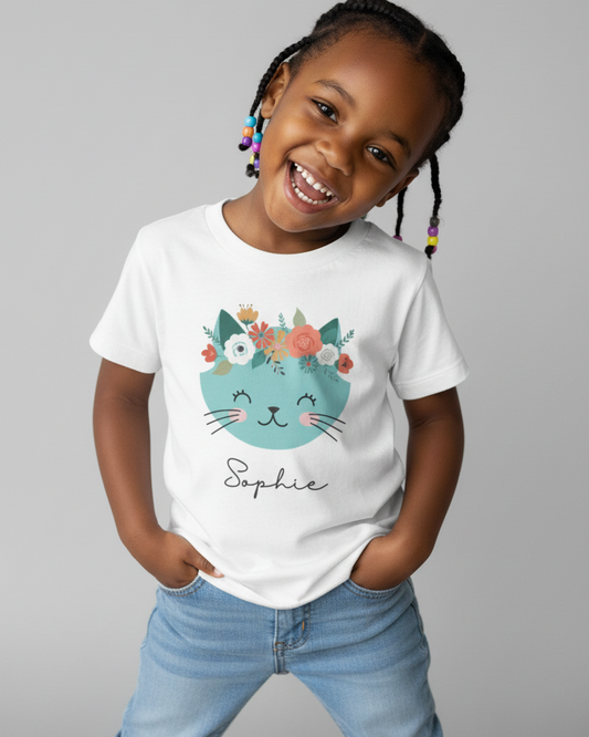 Happy child wearing white personalised floral cat t-shirt with custom name Sophie, studio portrait
