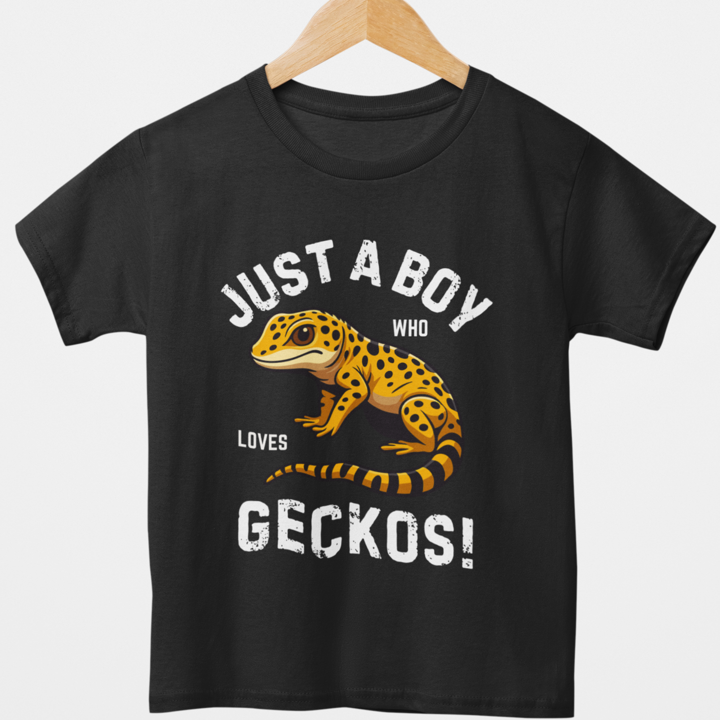 Kids black tee “Just a Boy Who Loves Geckos!” T-shirt with a cute yellow spotted gecko graphic - styled on a wooden hanger.