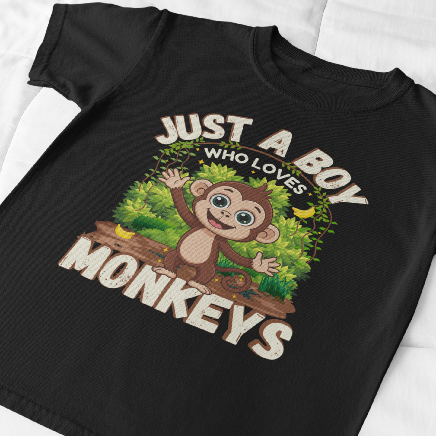 Close-up of kids monkey t-shirt graphic showing cartoon jungle monkey and “Just A Boy Who Loves Monkeys” text
