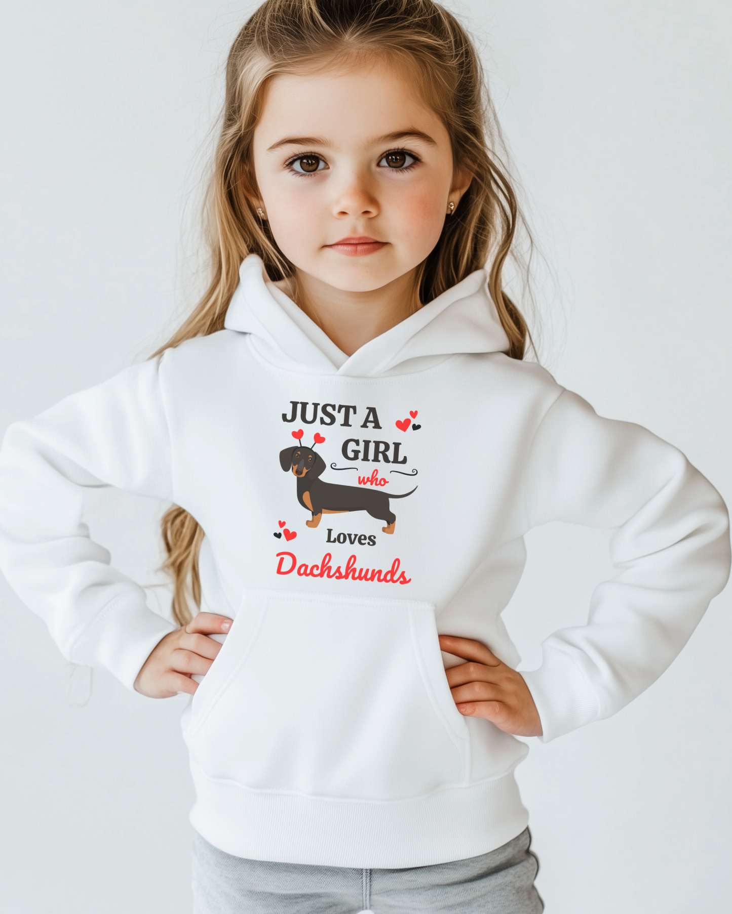 A girl wearing a white pullover hoodie with the text 'JUST A GIRL who loves Dachshunds' and an illustration of a Dachshund.