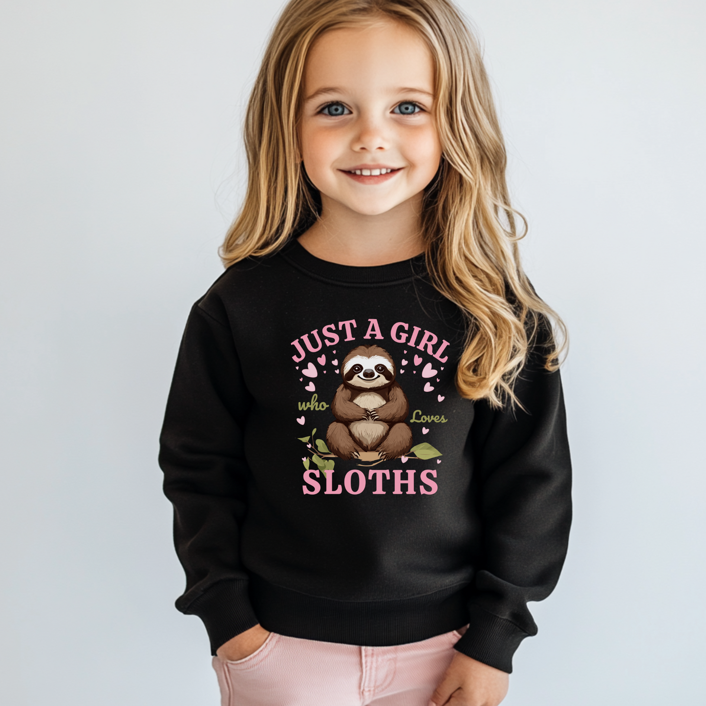 Young girl wearing a black sweatshirt with a sloth graphic and text on a plain background