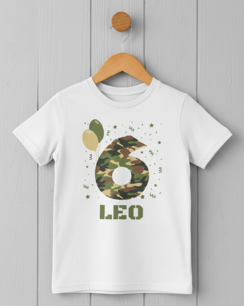 White children’s personalised birthday T-shirt on a wooden hanger featuring a camouflage number 6 and custom name Leo