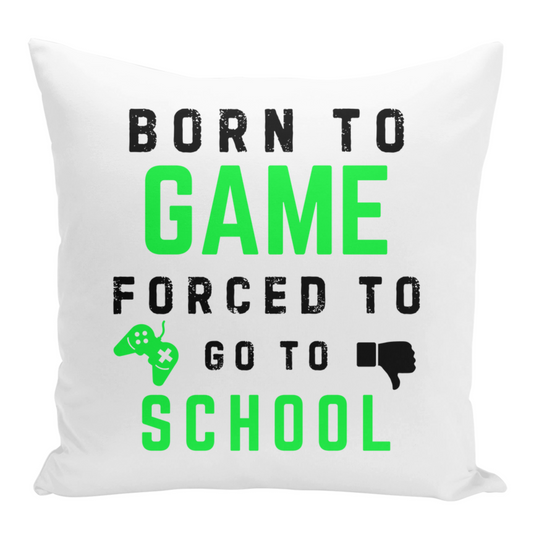 A white square cushion features bold black and bright green text that reads "BORN TO GAME" stacked above "FORCED TO GO TO SCHOOL". To the left of "GO TO" is a stylized bright green video game controller with a white "X" in the centre. To the right of "GO TO" is a black thumbs-down icon. The background of the cushion is plain white.