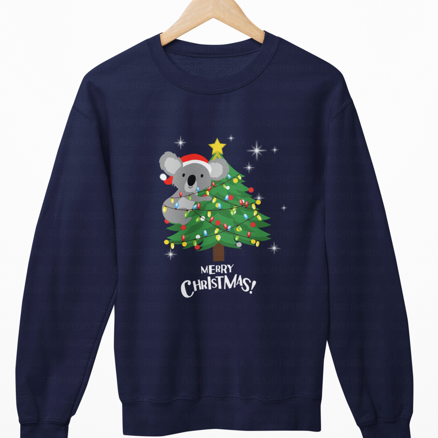 Navy blue sweatshirt with a Christmas design of a koala on a tree, hanging on a wooden hanger.