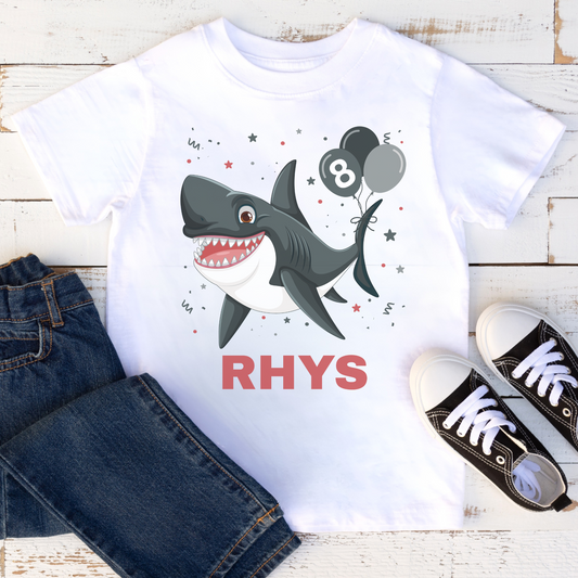 Personalised shark birthday t-shirt with name Rhys styled with kids jeans and trainers, casual outfit flat lay