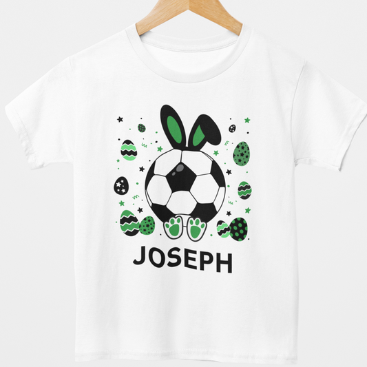 Personalised white kids T-shirt hanging on wooden hanger with football Easter bunny design and custom name Joseph