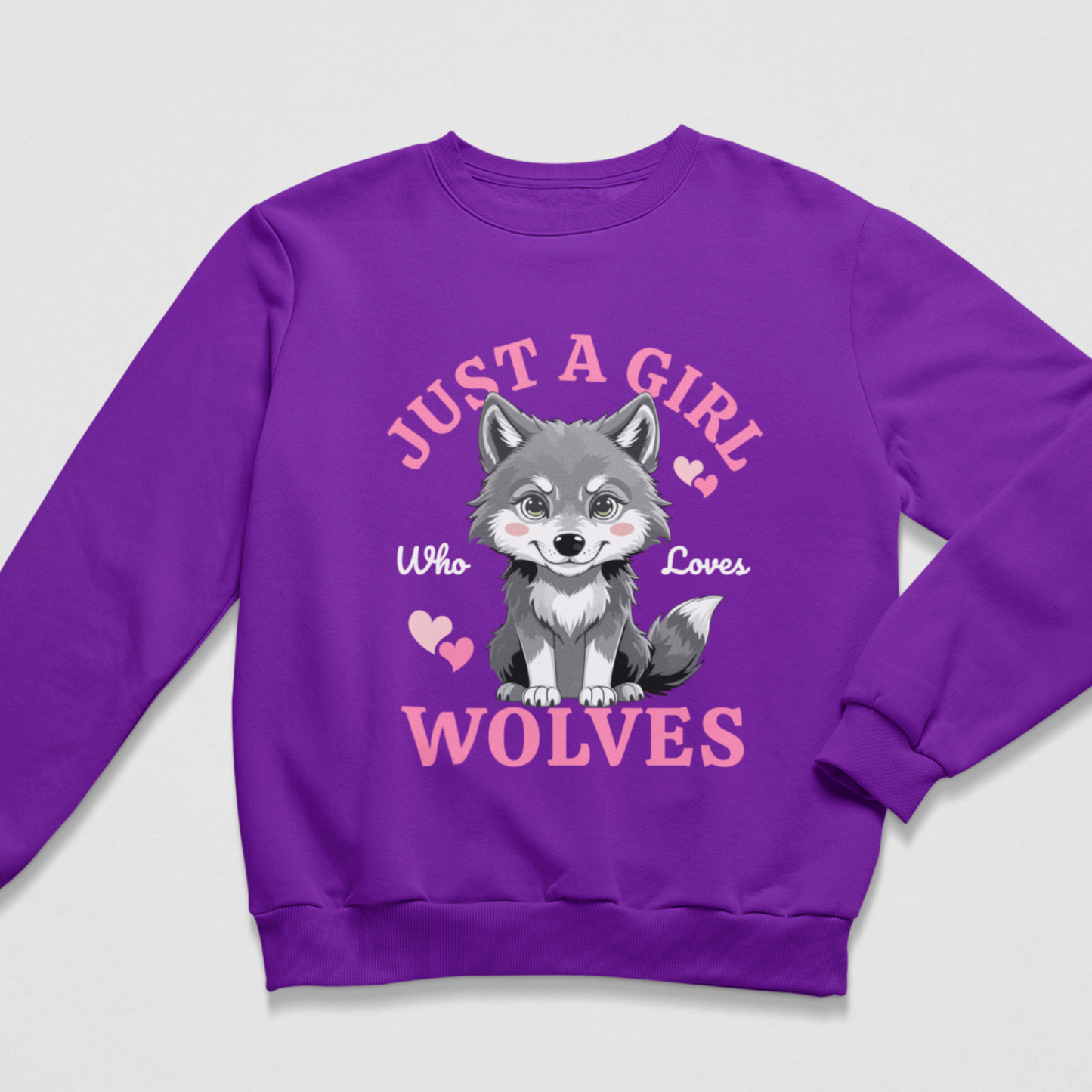 A kids purple crewneck sweatshirt featuring a cartoon illustration of a grey and white wolf with the text 'JUST A GIRL WHO LOVES WOLVES' in pink and white lettering.