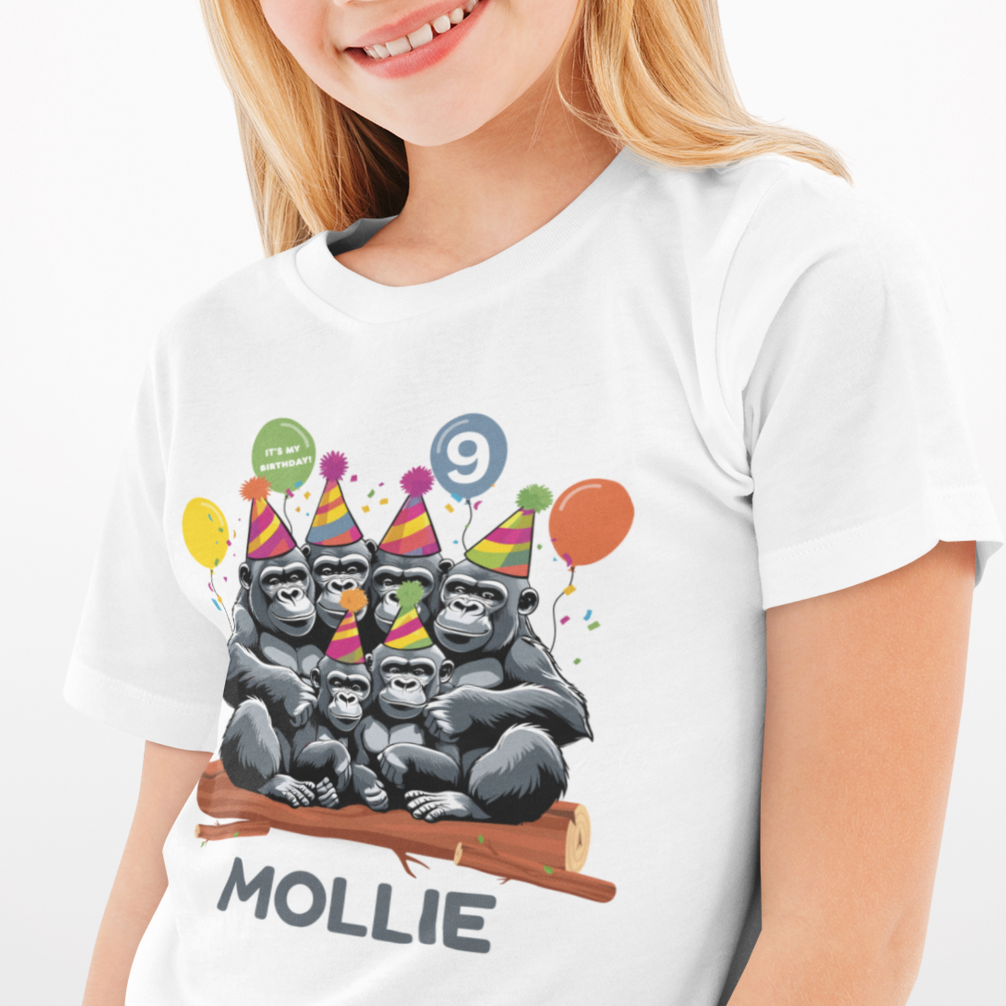 Girl wearing personalised birthday t-shirt with cartoon gorilla family, party hats, balloons, custom name and age.