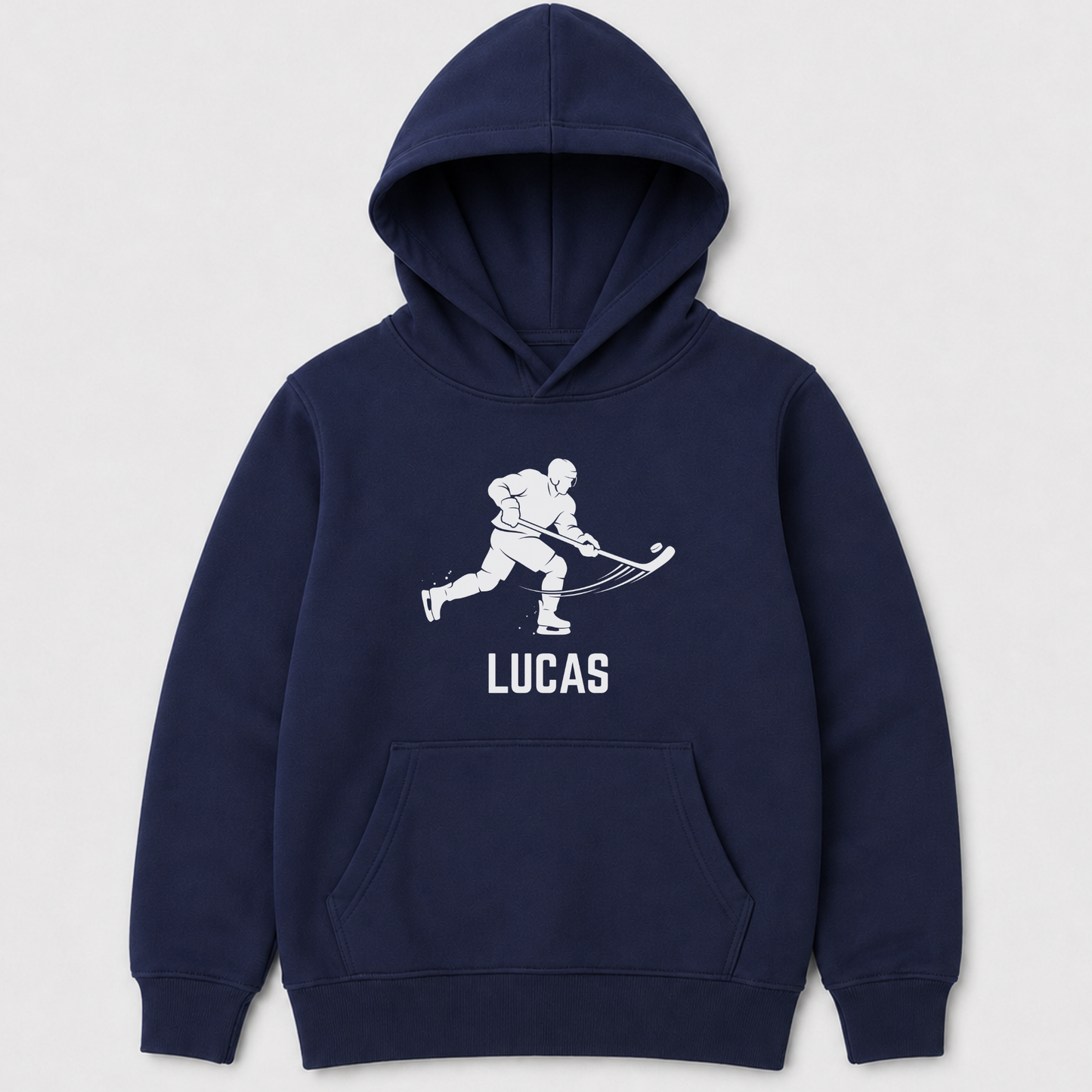 Navy blue kids pullover hoodie with a white graphic of a hockey player and the name 'LUCAS' printed on the chest, displayed against a light grey background.