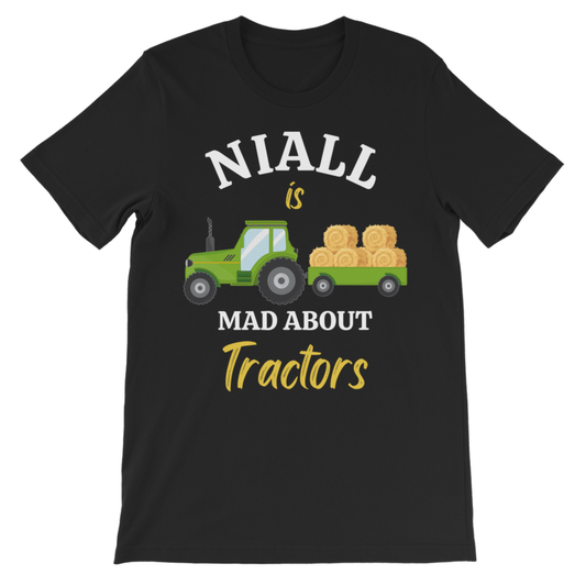 A kids black short-sleeve crewneck t-shirt with a graphic print on the front. The graphic features a green cartoon tractor pulling a trailer loaded with golden hay bales, with the text 'NIALL is MAD ABOUT Tractors' in white and yellow lettering.