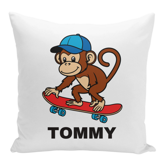 A white square cushion cover featuring a cartoon monkey wearing a blue cap and riding a red skateboard. The name "TOMMY" is printed below the monkey.