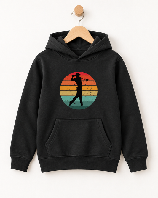 Black kids’ hoodie with a retro striped sunset and golfer silhouette design, displayed on a wooden hanger and wall hook.