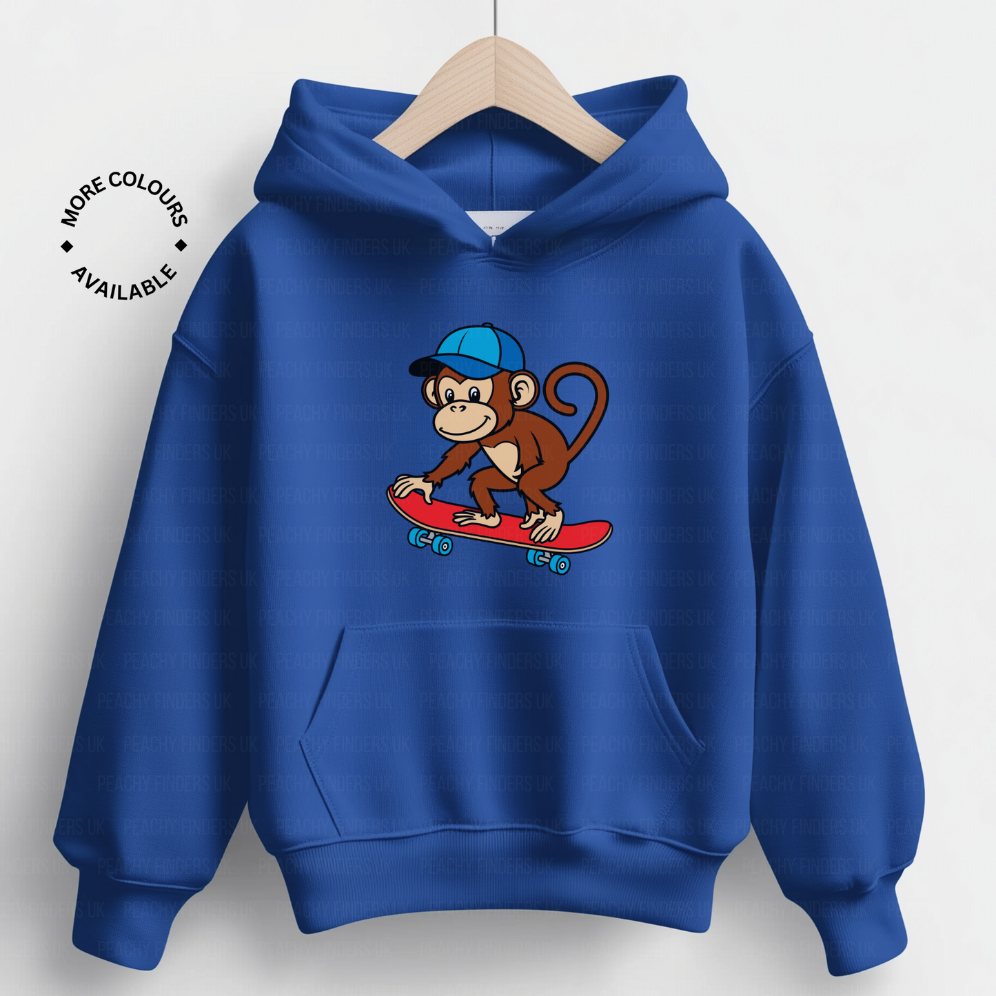 A child's blue hoodie on wooden hanger with a cartoon monkey wearing a blue cap riding a red skateboard graphic.