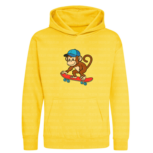 Kids yellow hoodie with a cartoon monkey on a red skateboard design.
