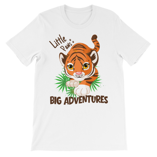 A kids white short-sleeve crewneck t-shirt featuring a cartoon graphic of a cute tiger cub walking on green leaves, with the text 'Little Paws, BIG ADVENTURES".
