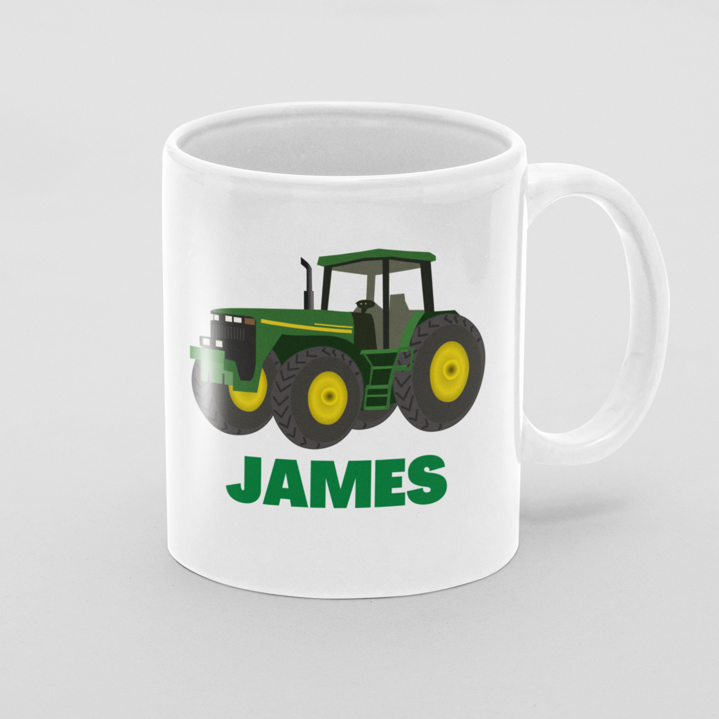 Personalised white mug with a green and yellow tractor and the name "JAMES" in bold green text.