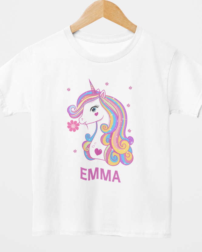 Kids personalised unicorn t-shirt on hanger with name “Emma”, white tee featuring rainbow unicorn graphic and floral accents