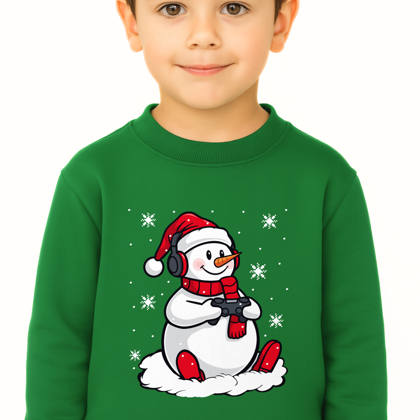 Boy modelling a green sweatshirt featuring a fun design of a snowman with headphones, red Santa hat, scarf, and game controller, surrounded by snowflakes.