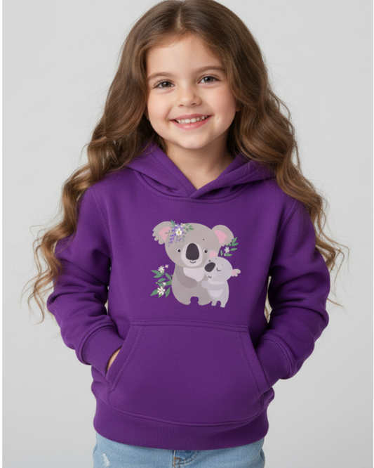 Smiling young girl wearing a purple kids hoodie featuring a sweet koala and baby koala illustration, studio portrait.