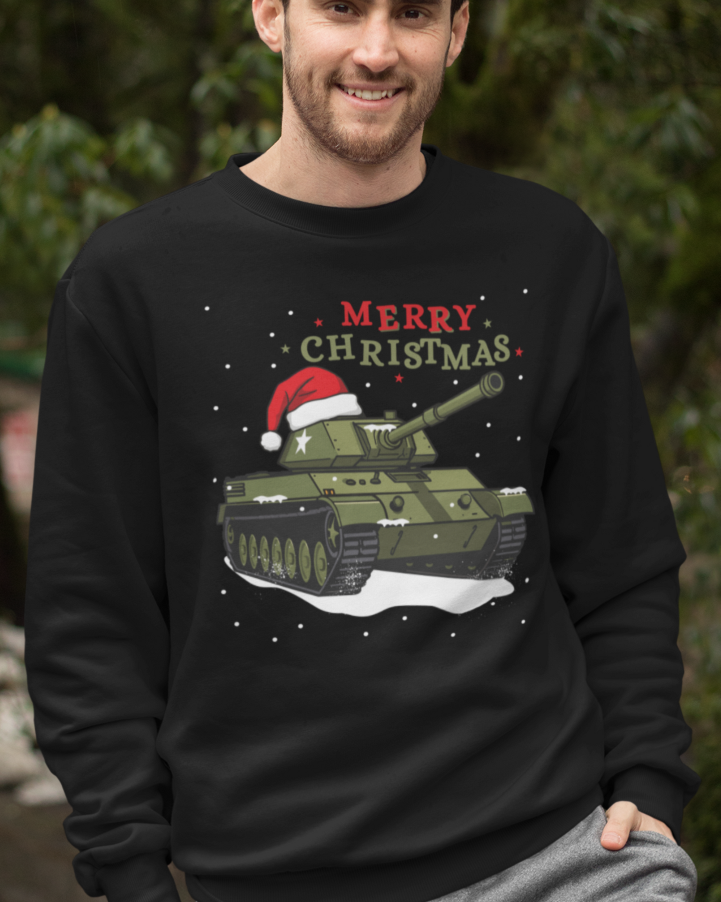 A man wearing a black sweatshirt with a Christmas tank design and 'Merry Christmas' text outdoors.