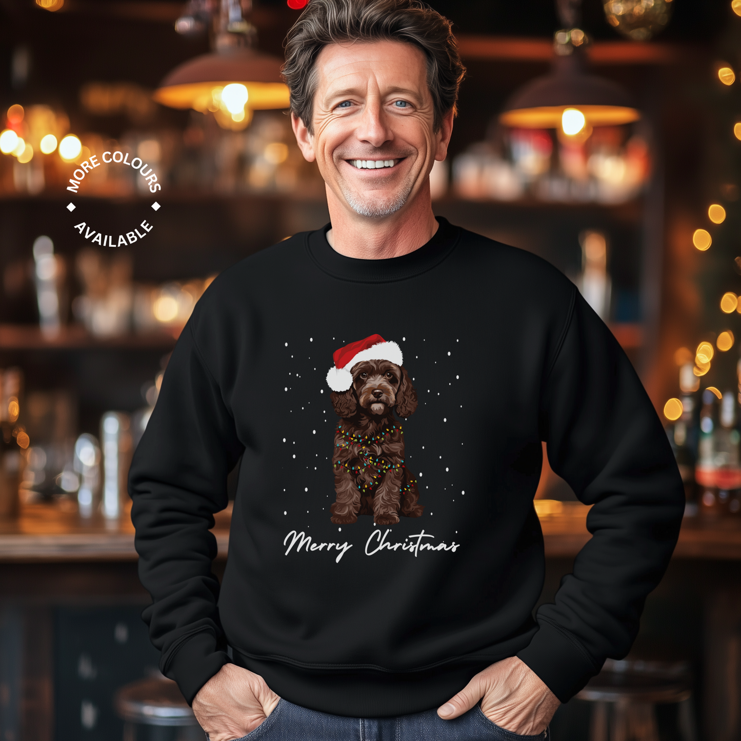 Man wearing a black Christmas sweater with a chocolate brown cockapoo illustration and 'Merry Christmas'.