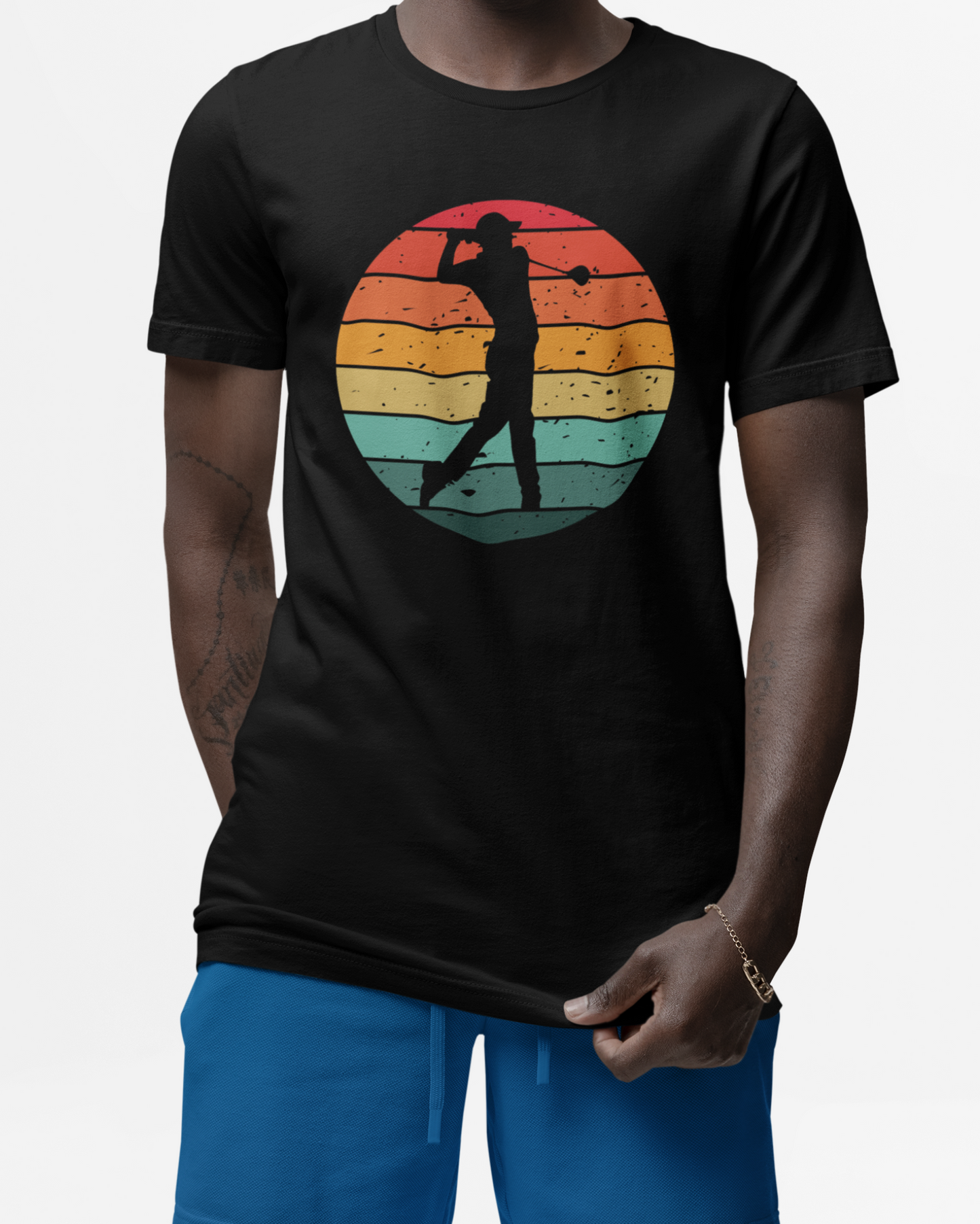 Man wearing a black t-shirt with a colourful graphic of a silhouette golfer on a vintage sunset background