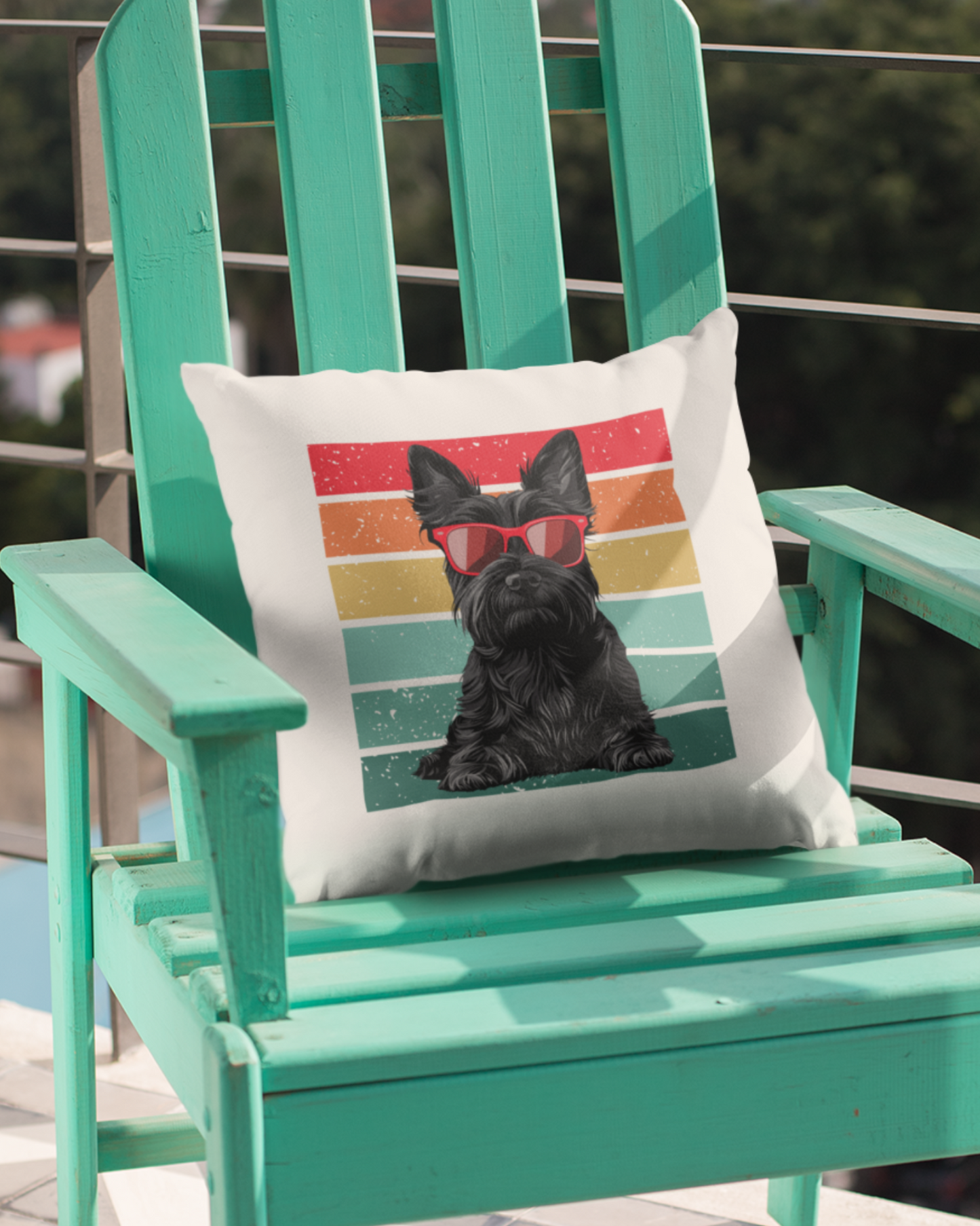 A canvas cushion cover featuring a black Scottish Terrier with red sunglasses, placed on a green Adirondack chair outdoors.