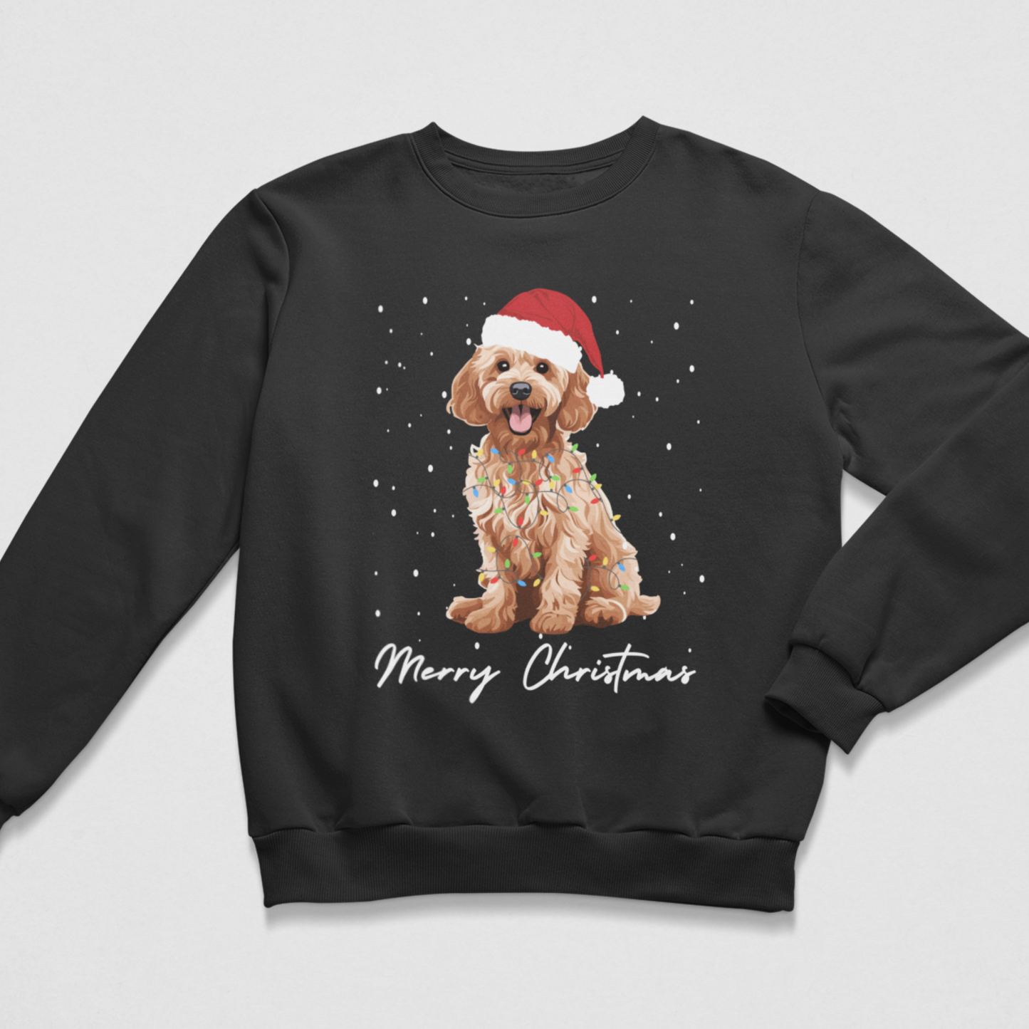 A kids black crewneck sweatshirt featuring a graphic of a golden cockapoo dog wearing a Santa hat and Christmas lights, with 'Merry Christmas' written below on a light grey background.