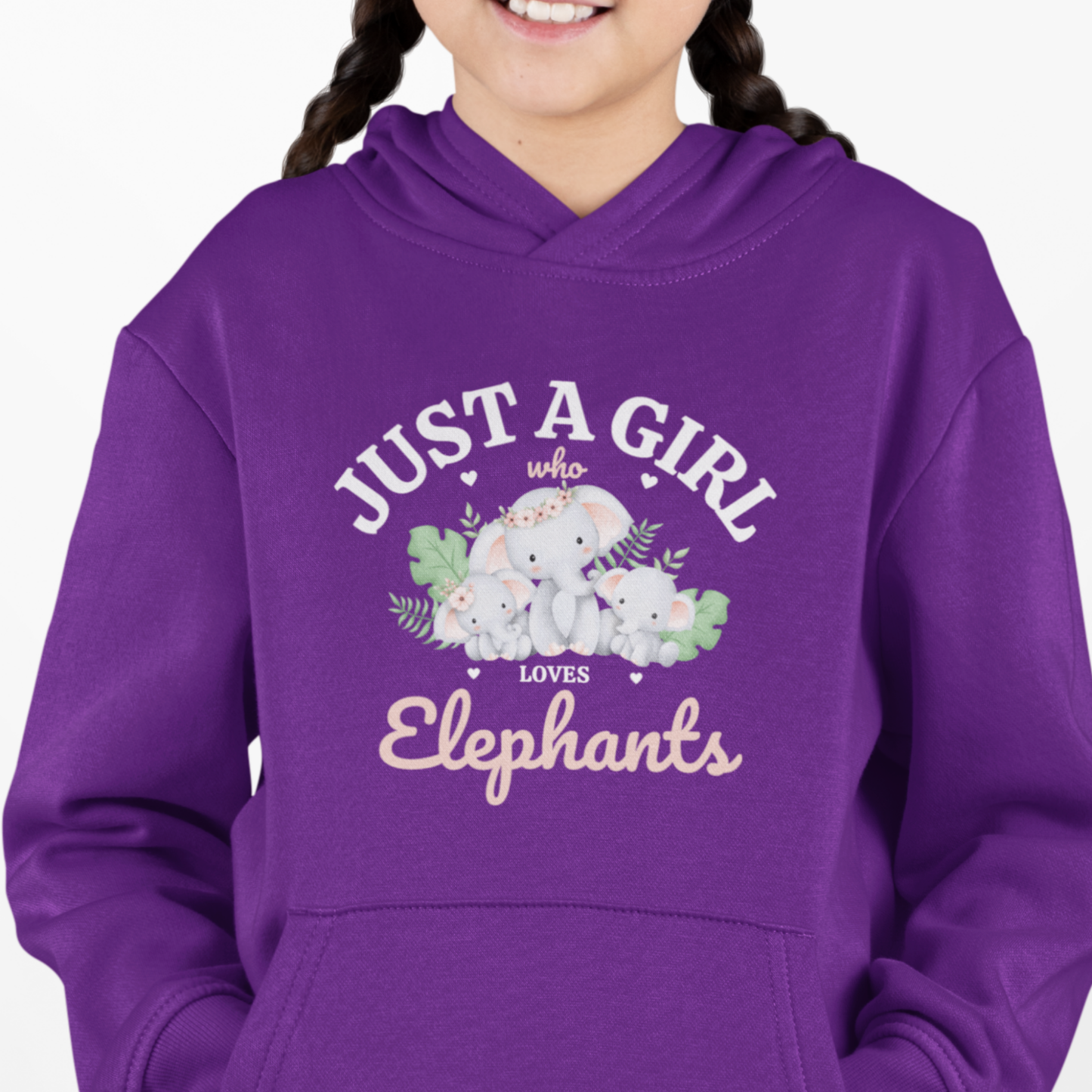 Girl wearing a purple hoodie with the text “Just a Girl Who Loves Elephants” and a sweet design of a mother and baby elephants surrounded by leaves and hearts