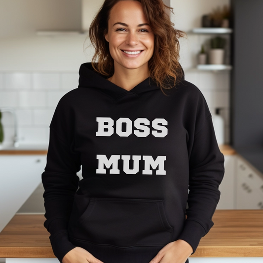 A woman wearing a black hoodie with white printed words saying "boss mum" 