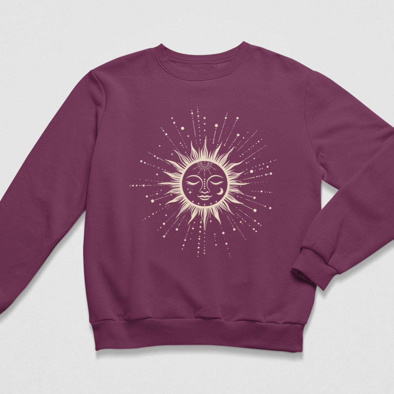Deep plum purple celestial sun jumper displayed flat showing a detailed sun, moon, and star burst graphic across the chest.