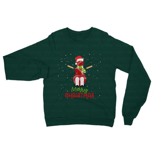 Dark green Christmas sweatshirt featuring a festive snowman made from stacked red cricket balls, cricket stumps, and wooden bat arms, wearing a Santa hat and scarf with snowflakes and “Merry Christmas” text.