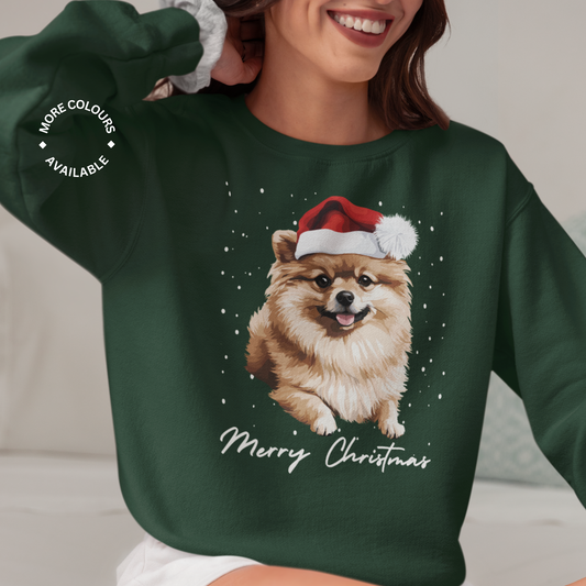 Woman wearing a dark green Merry Christmas-themed sweatshirt with a Pomeranian wearing a Santa hat, with falling snow.