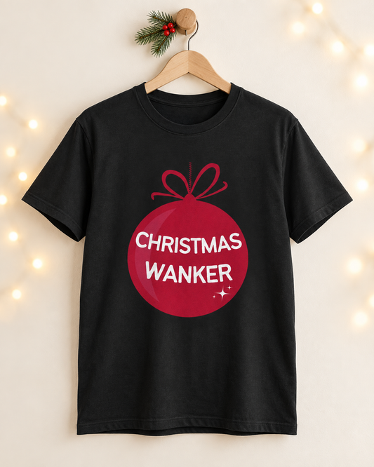 Adult black Christmas Wanker T-shirt with a red bauble design displayed on a wooden hanger.