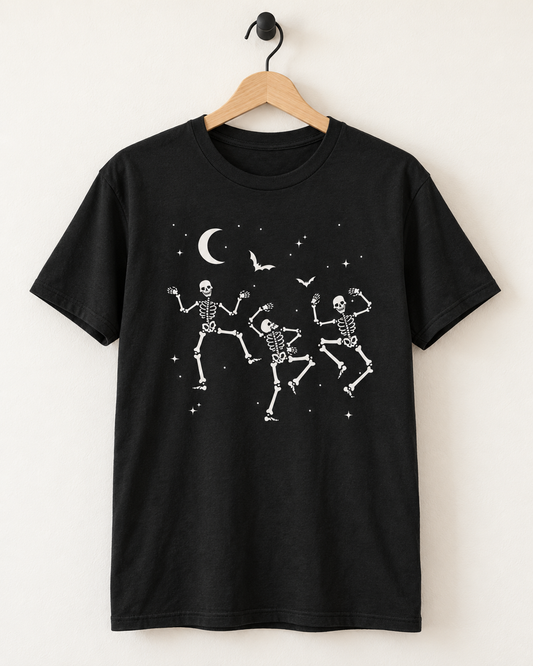 Black dancing skeletons Halloween T-shirt displayed on a wooden hanger and matte-black wall hook.
